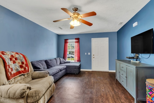 living room featuring ceiling fan and dark hardwood / wood-style floors