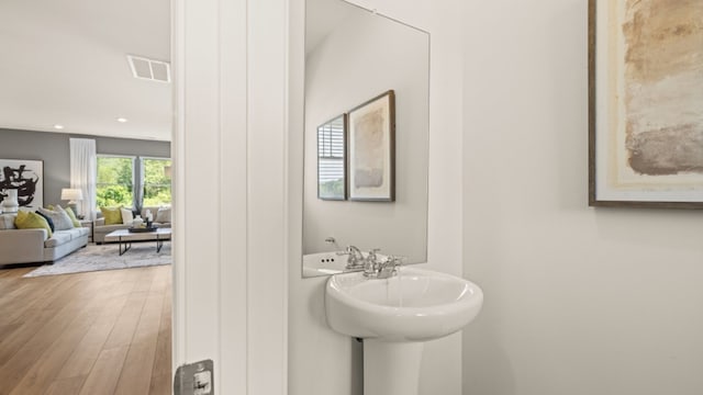 bathroom with wood-type flooring