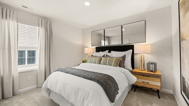 carpeted bedroom featuring multiple windows