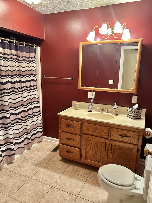 bathroom with toilet, vanity, tile patterned floors, walk in shower, and a textured ceiling