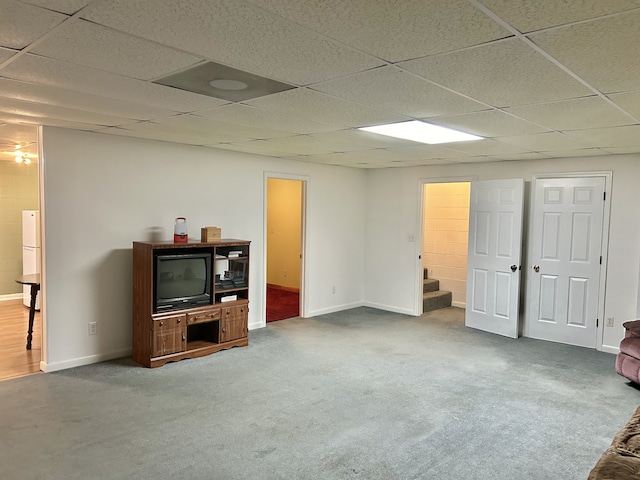 living room with a drop ceiling and carpet floors