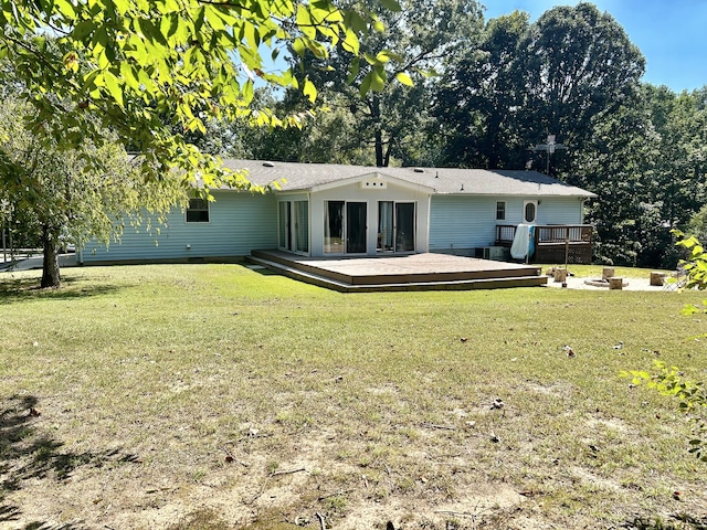 back of property featuring a yard and a wooden deck