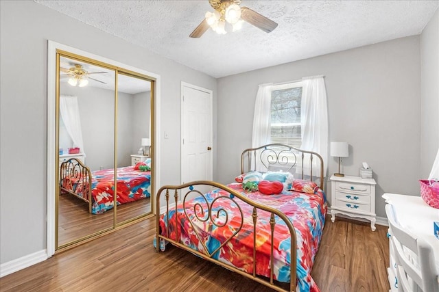 bedroom with ceiling fan, wood finished floors, a closet, and a textured ceiling