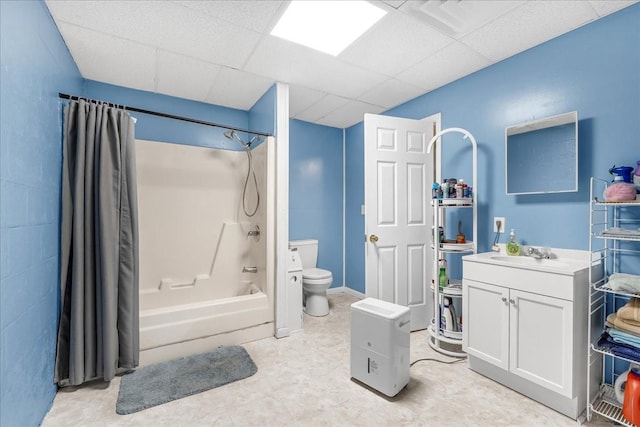 bathroom featuring a paneled ceiling, toilet, shower / tub combo with curtain, and vanity