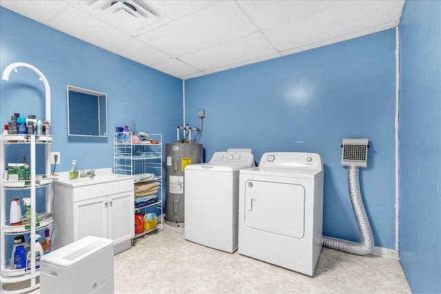 laundry area featuring visible vents, independent washer and dryer, a sink, water heater, and cabinet space