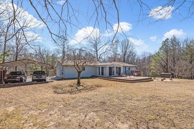 view of front of home featuring a detached carport and a wooden deck