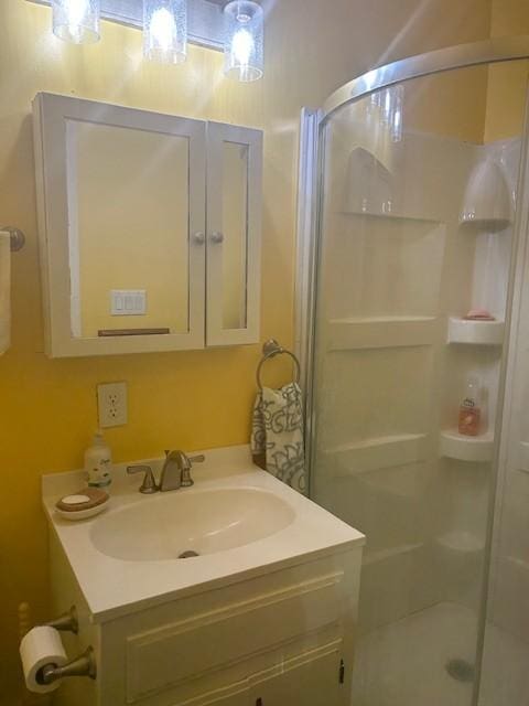 bathroom featuring a stall shower and vanity