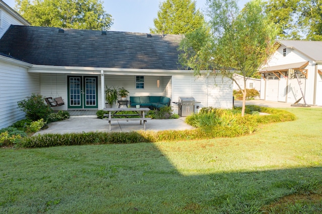 rear view of house featuring a porch and a lawn