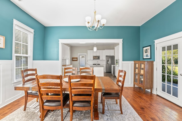 dining area with hardwood / wood-style flooring and a chandelier