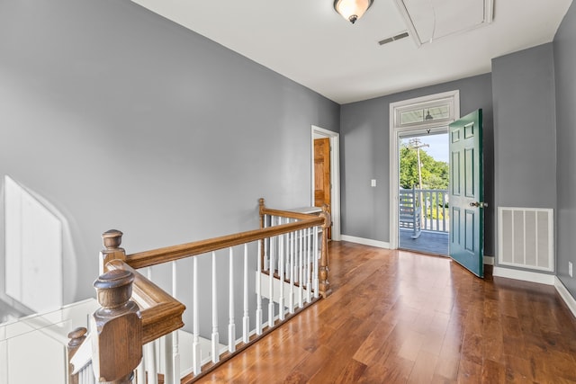 hallway with hardwood / wood-style flooring