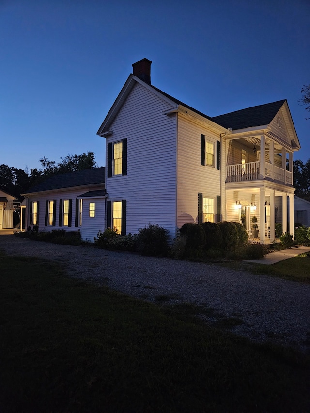 view of property exterior with a yard and a balcony