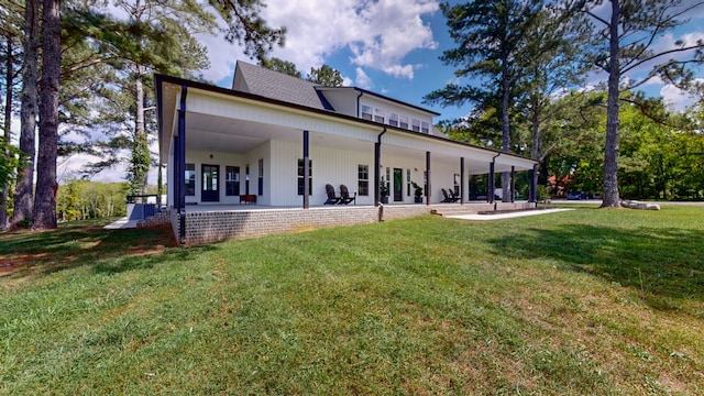 rear view of property featuring a lawn