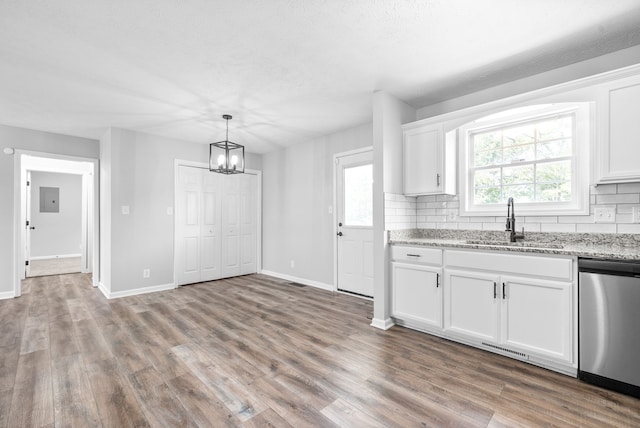 kitchen featuring stainless steel dishwasher, hardwood / wood-style flooring, and white cabinetry