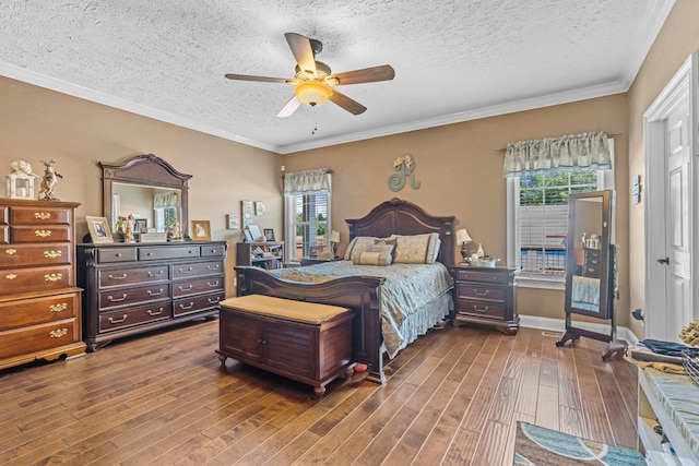 bedroom with a textured ceiling, crown molding, ceiling fan, and wood-type flooring