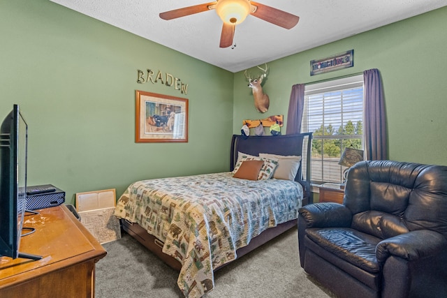 carpeted bedroom featuring ceiling fan and a textured ceiling