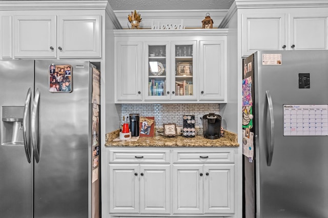 kitchen with stainless steel refrigerator, tasteful backsplash, stainless steel fridge with ice dispenser, and white cabinets