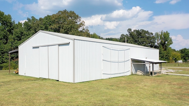 view of outbuilding featuring a lawn