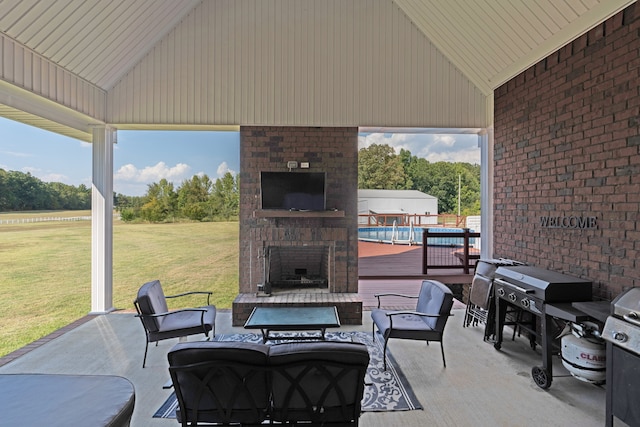 view of patio / terrace with an outdoor brick fireplace