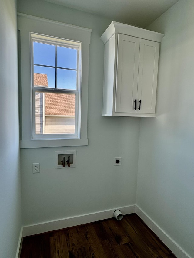 clothes washing area featuring cabinets, dark hardwood / wood-style flooring, washer hookup, and hookup for an electric dryer