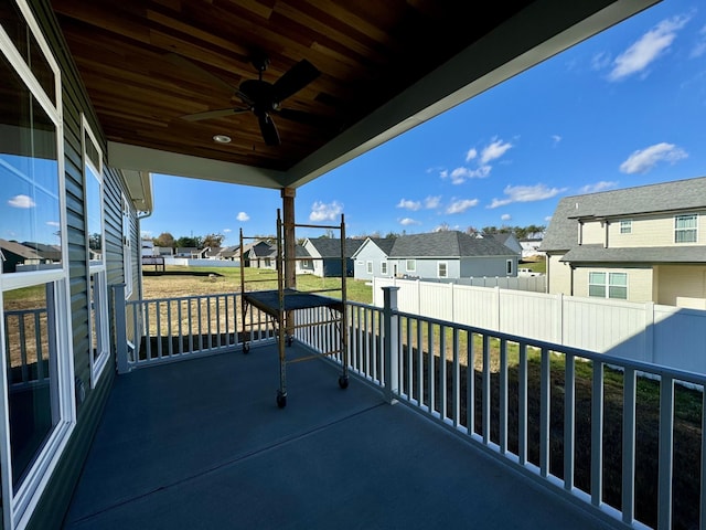 balcony with a porch and ceiling fan