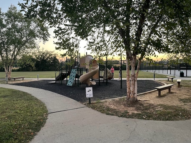 playground at dusk with a lawn