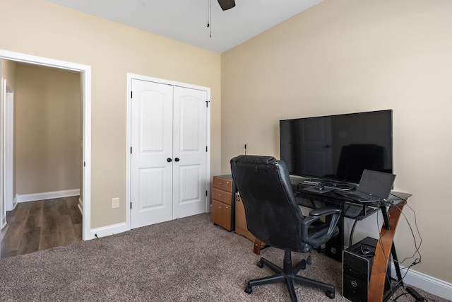 carpeted home office with ceiling fan and vaulted ceiling