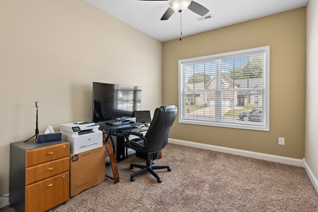 carpeted office featuring ceiling fan