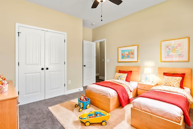 bedroom with dark colored carpet, ceiling fan, and a closet