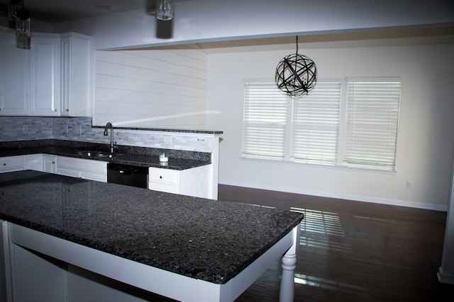 kitchen featuring sink, decorative light fixtures, dark wood-type flooring, dishwasher, and white cabinetry