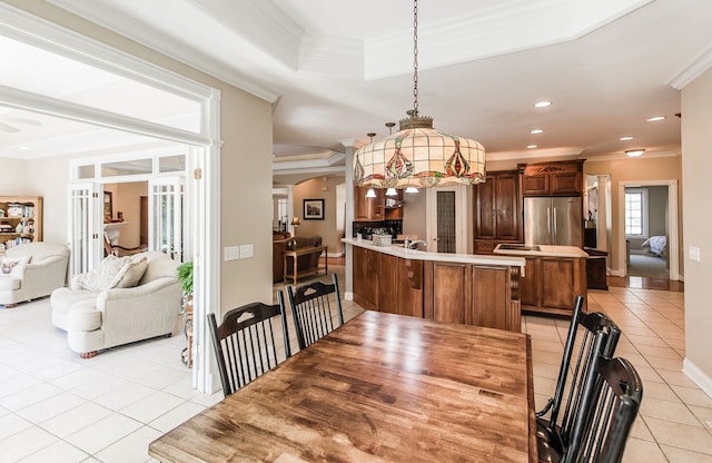 tiled dining area featuring ornamental molding