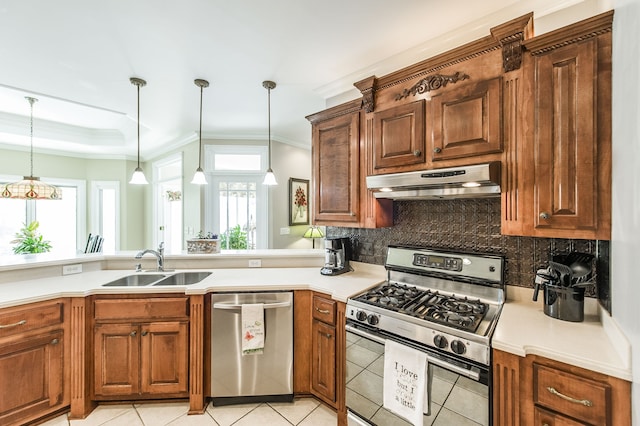 kitchen featuring plenty of natural light, appliances with stainless steel finishes, pendant lighting, and sink