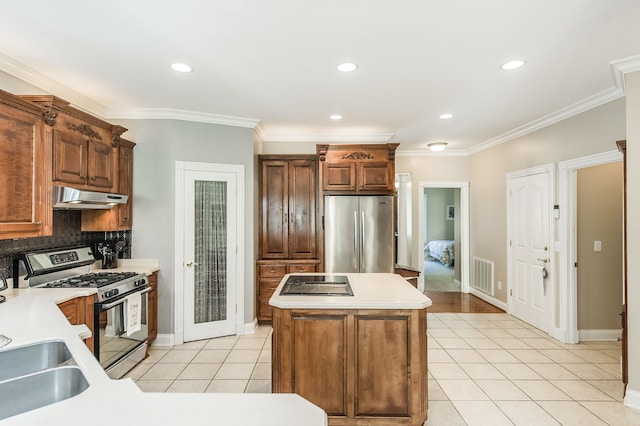 kitchen with crown molding, a center island, light tile patterned floors, and appliances with stainless steel finishes