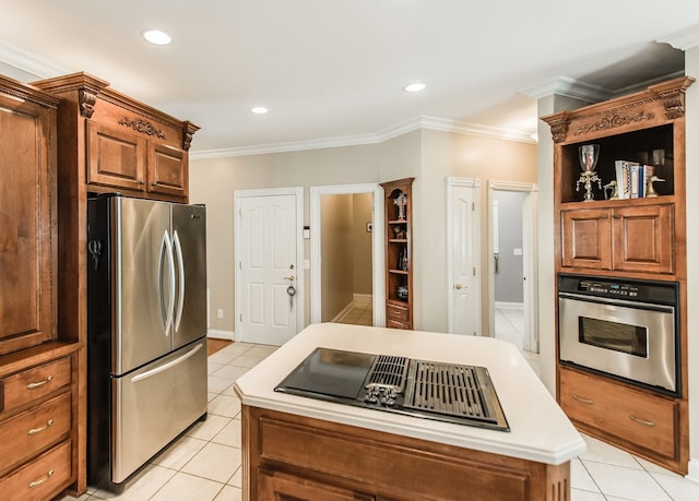 kitchen featuring crown molding, a center island, stainless steel appliances, and light tile patterned floors