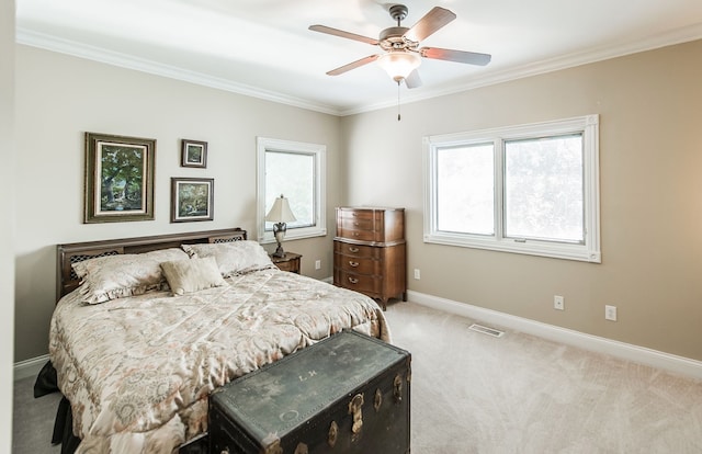 bedroom with crown molding, light colored carpet, and ceiling fan