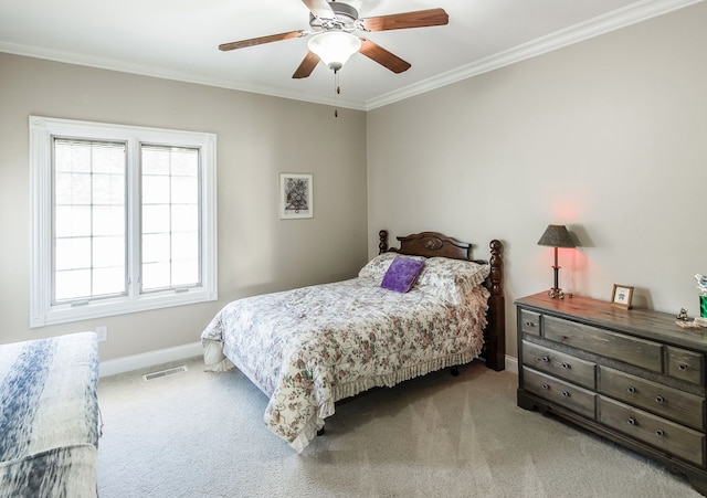 carpeted bedroom with ceiling fan and crown molding