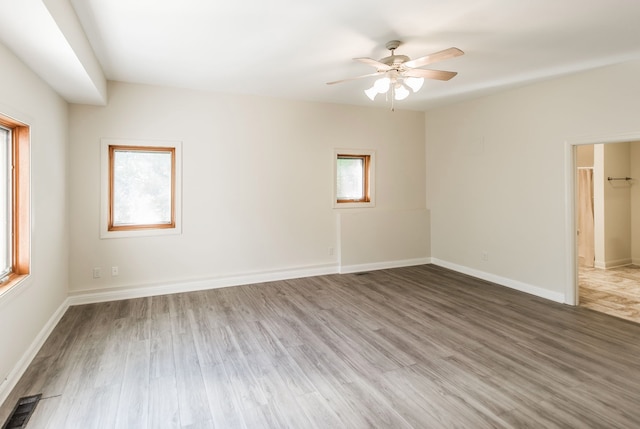 unfurnished room with ceiling fan and wood-type flooring