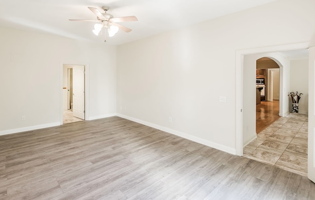 spare room with ceiling fan and light hardwood / wood-style floors