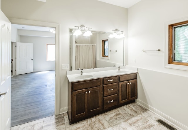 bathroom featuring hardwood / wood-style flooring, plenty of natural light, and vanity