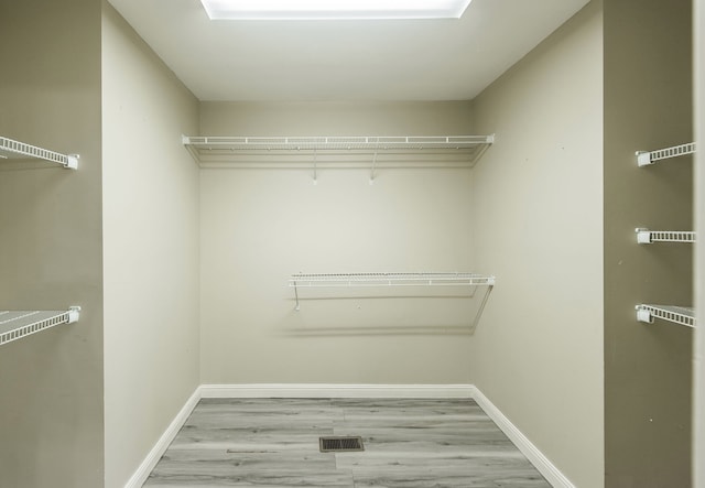 walk in closet featuring light hardwood / wood-style floors