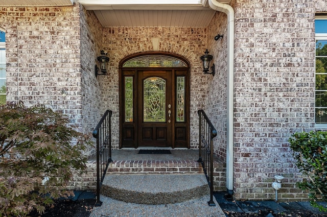 view of exterior entry featuring covered porch