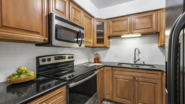 kitchen featuring appliances with stainless steel finishes, backsplash, and sink