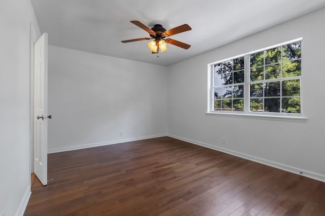 empty room featuring dark wood-type flooring and ceiling fan