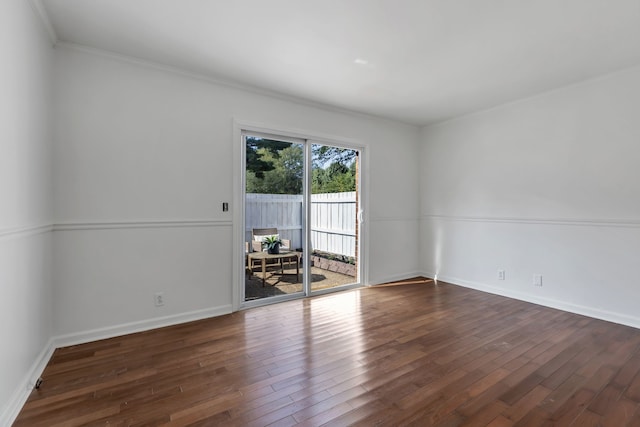 unfurnished room with dark hardwood / wood-style flooring and ornamental molding