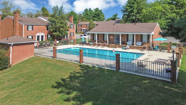 view of pool with a yard and a patio area