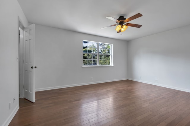 empty room featuring ceiling fan and dark hardwood / wood-style floors