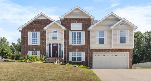 raised ranch with a garage, central AC unit, and a front lawn