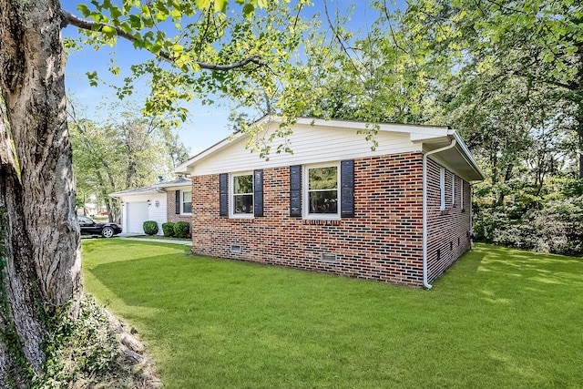 view of side of property with a garage and a yard