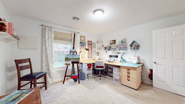 office space featuring light colored carpet and a textured ceiling