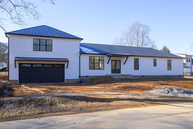 modern inspired farmhouse with a garage