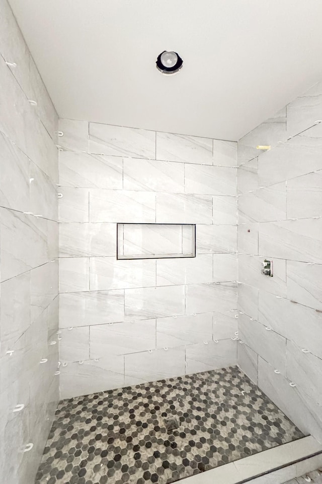 bathroom with tiled shower